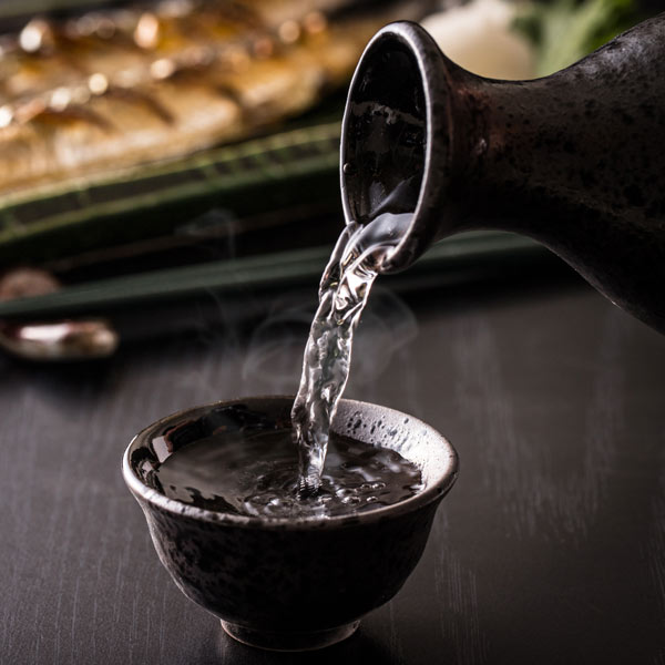 Pouring warmed sake
