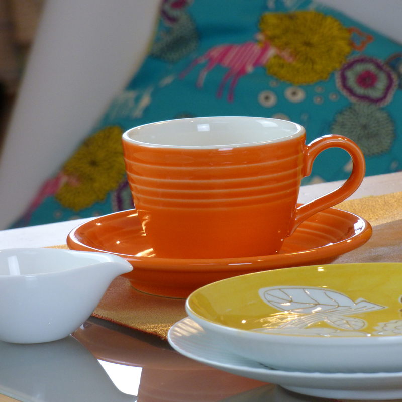 Brightly coloured cup and plates