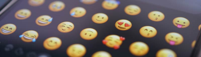 Emojis on a phone keyboard - Photo by Tim Witzdam on Unsplash