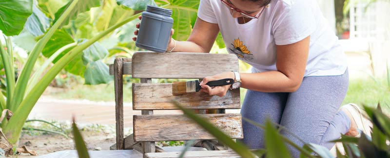 Woman upcycling a wooden chair