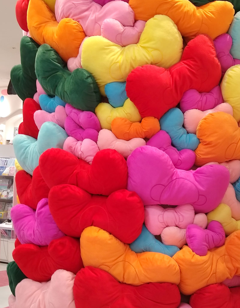 Colourful stuffed bows piled up in shop display