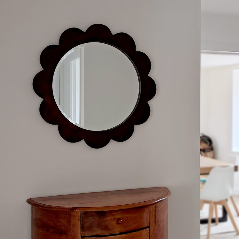 A kawaii flower-shaped mirror in a minimalist hallway