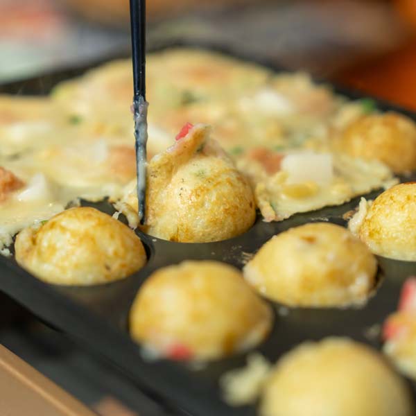 Japanese takoyakis cooking in a pan
