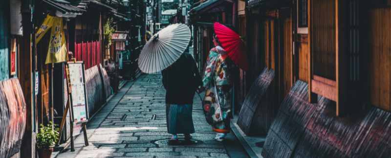Japanese women walking with parasols