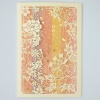 Intricate laser-cut card with floral and fan design