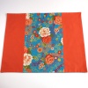 Japanese fabric placemat with orange and turquoise floral design