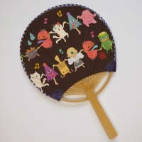 Japanese 'uchiwa' fan with colourful monsters design on black background