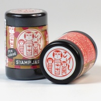 Pre-inked Japanese hanko stamp with a kokeshi doll design