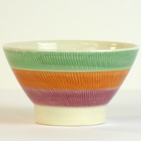 Hasami ware Japanese ceramic bowl with green, orange and red striped pattern