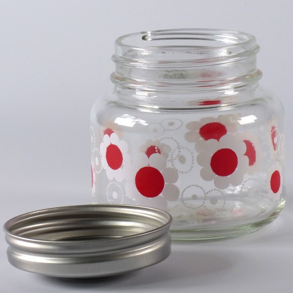 Glass storage jar with retro red and white floral design
