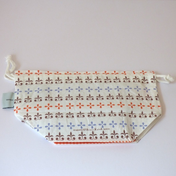 Reverse side of Little Red Riding Hood cotton lunch bag featuring blue, brown and red heraldic pattern