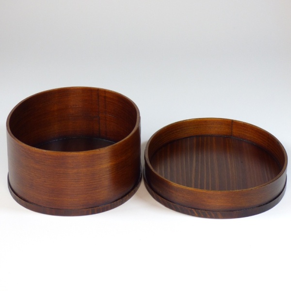 Wooden bento box with lid beside it