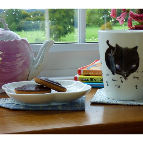 Table setting with Black Cat side plate and mug