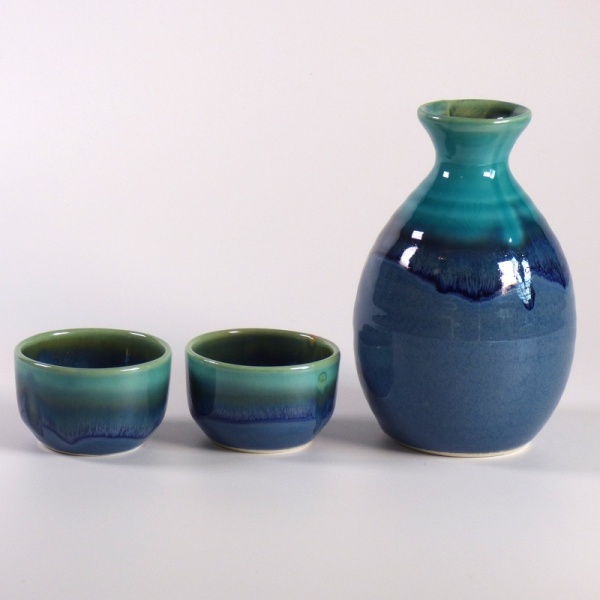 Blue-green glazed ceramic sake jug and two cups