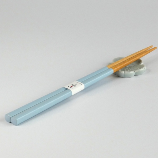 Pastel blue chopsticks with matching pale blue flower shaped chopstick rest