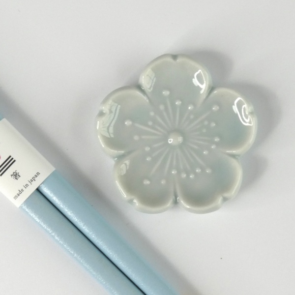 Pastel blue chopsticks with matching pale blue flower shaped chopstick rest