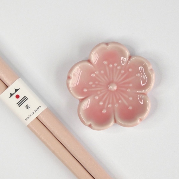 Pastel pink chopsticks with matching pink flower shaped chopstick rest