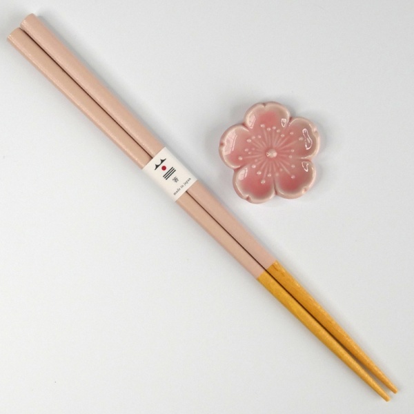 Pastel pink chopsticks with matching pink flower shaped chopstick rest