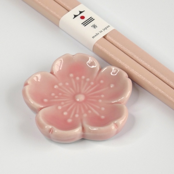 Close up of pale pink blossom ceramic chopstick rest