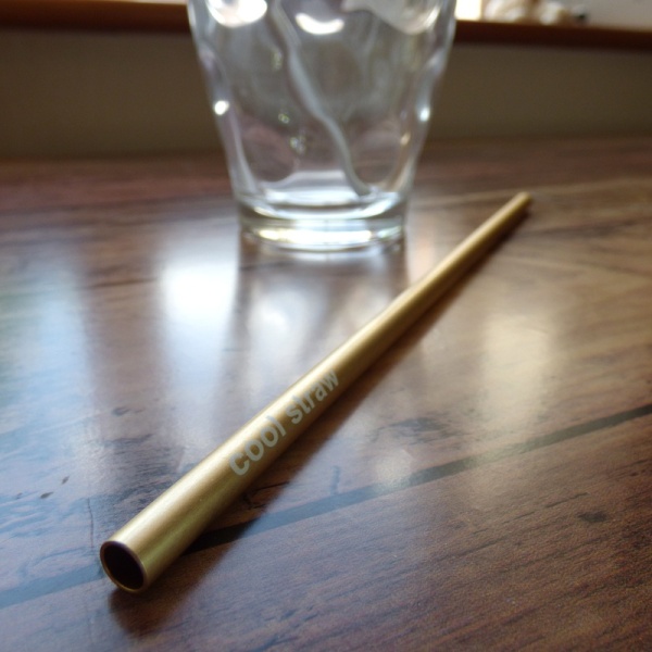 Gold coloured metal drinking straw