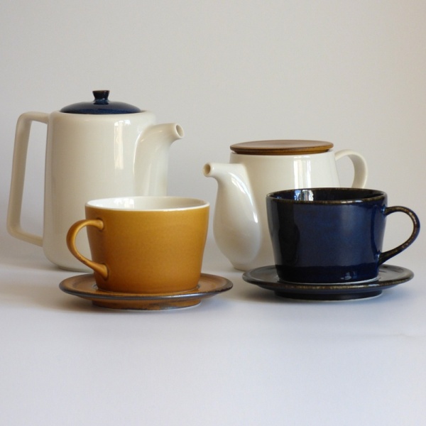 Dark blue and caramel coloured Japanese cups and saucers with Japanese teapots