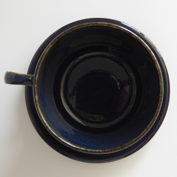 Top down, inside of dark blue cup and saucer