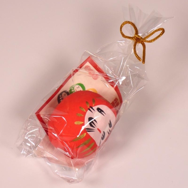 Red mini Daruma doll in wrapping