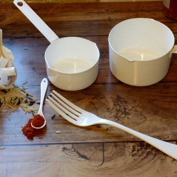 White enamel dessert fork with other kitchen implements