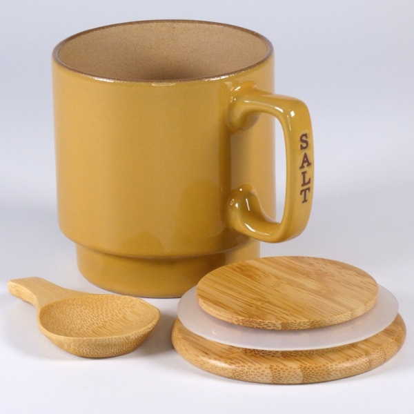 Ceramic mustard coloured salt storage container with wooden lid and scoop