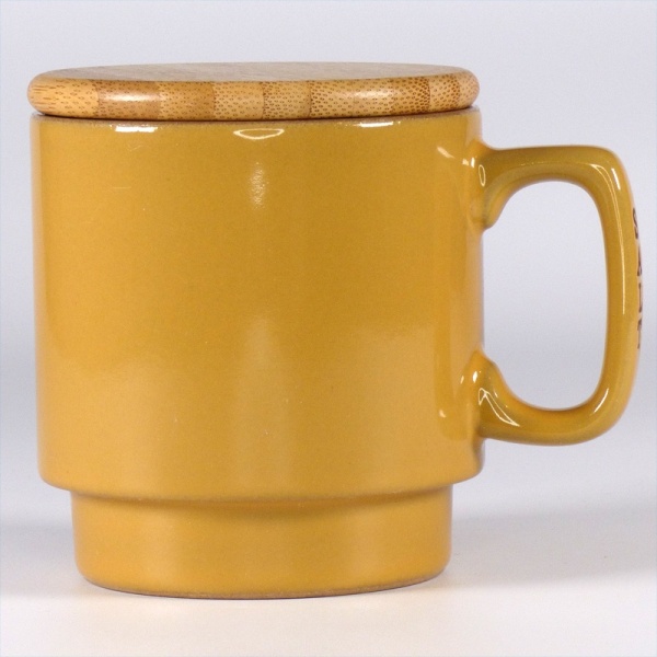 Mustard coloured ceramic storage container for salt
