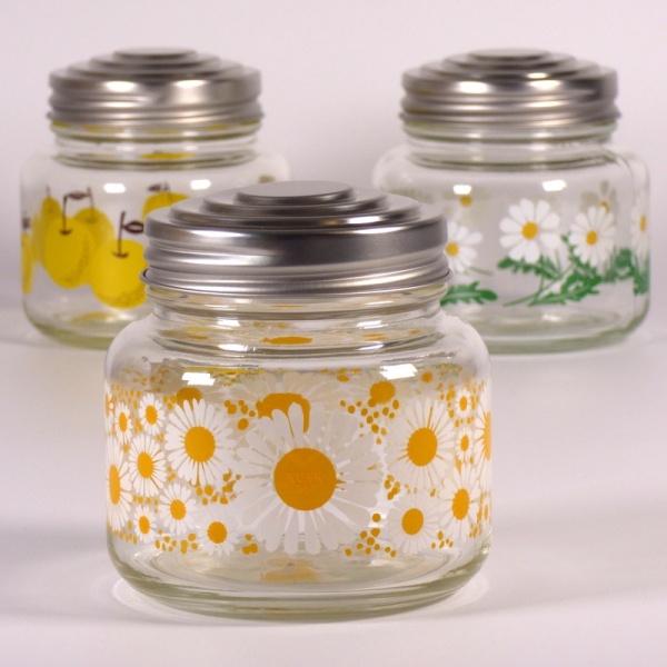 Three glass storage jars