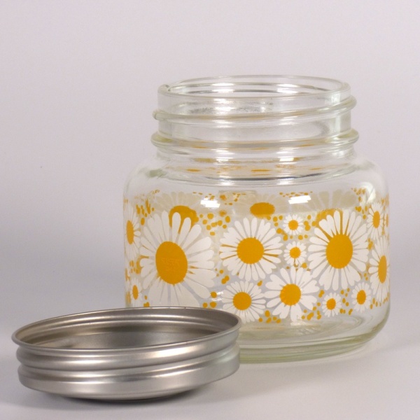 Retro style glass storage jar with bright daisy pattern