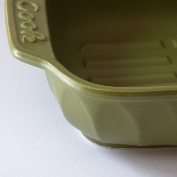 Close up of green ceramic gratin dish