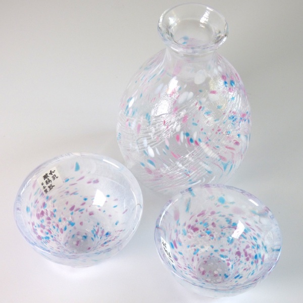 Two speckled glass Japanese sake cups with matching serving jug