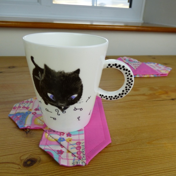 Black Cat mug on pink fabric coaster