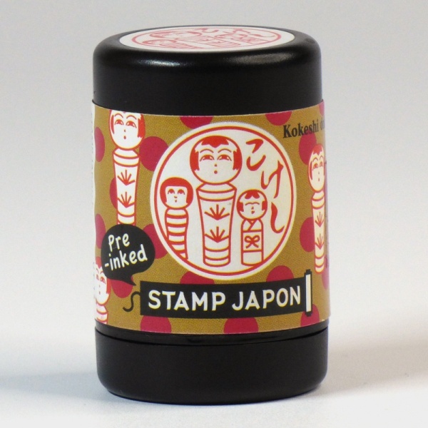 Pre-inked Japanese hanko stamp with a kokeshi doll design