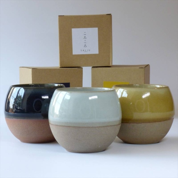 Three Japanese cups in blue, grey and yellow with boxes
