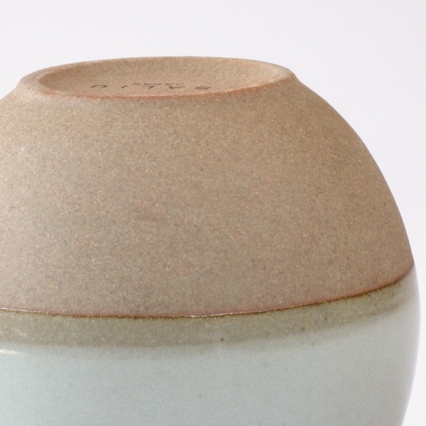 Showing the contrasting unglazed surface and upper dove grey glazed surface of the cup