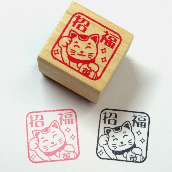 Wood and rubber lucky cat stamp with printed examples