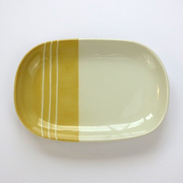 Oval Japanese ceramic plate with yellow dipped glaze design