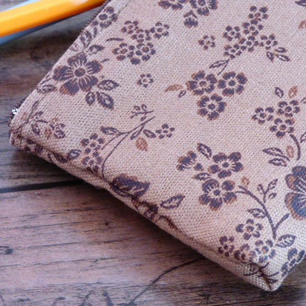 Close up of canvas zip bag with brown floral design