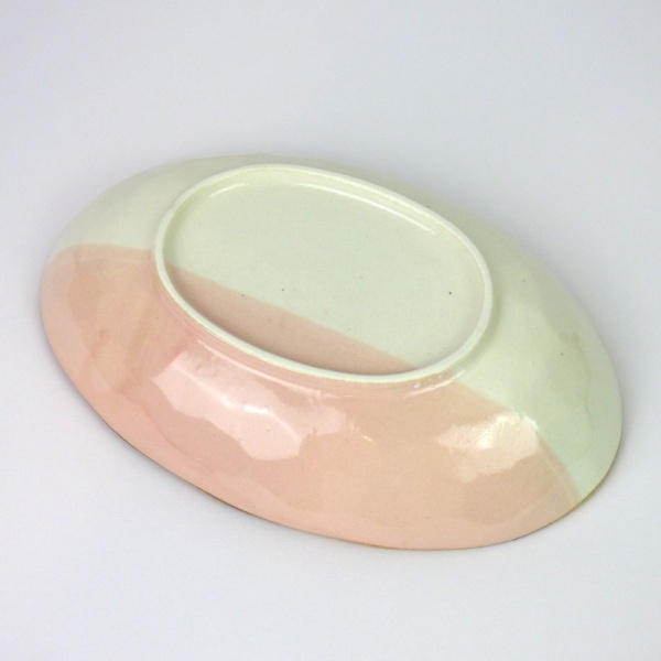 Pink and white oval curry plate underside
