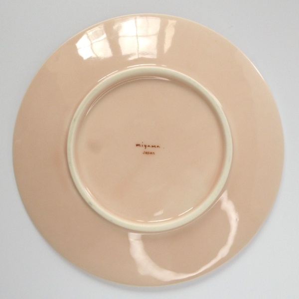 Underside of pale pink Japanese side plate