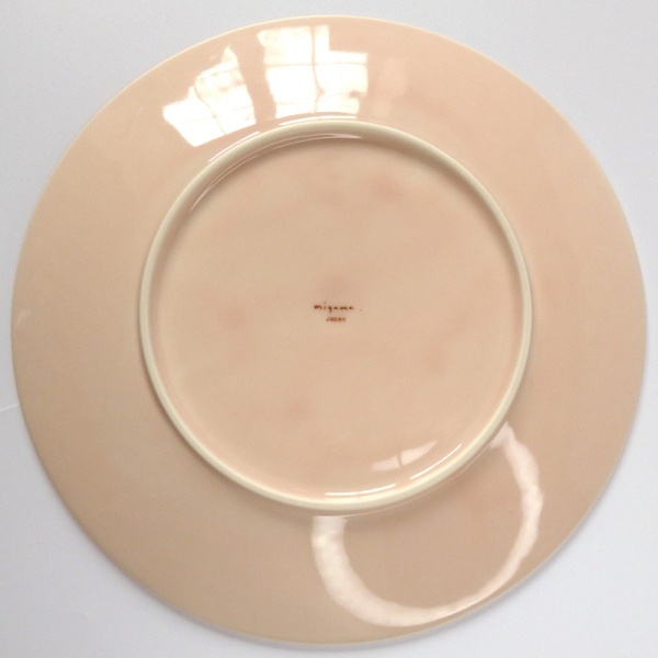 Underside of pale pink Japanese side plate