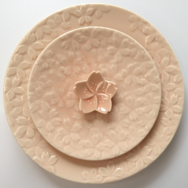 Matching large and small pink cherry blossom plates with chopstick rest