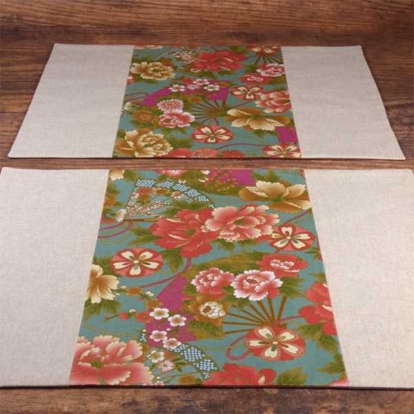 Two Japanese fabric placemat with vibrant flowers and fans design