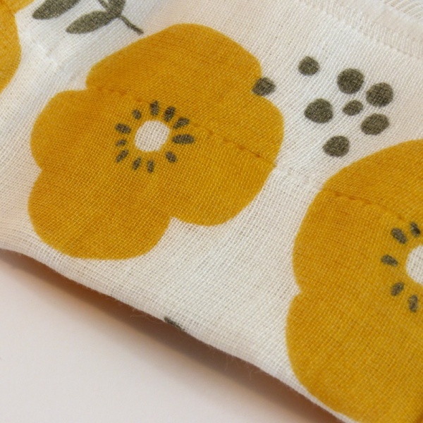 Reusable fabric kitchen cloth with yellow flowers close up