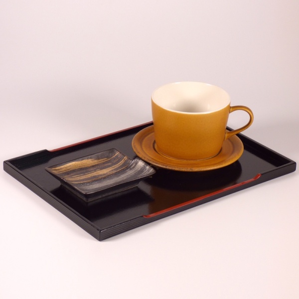 Coffee cup and small dish on black lacquered Japanese tray