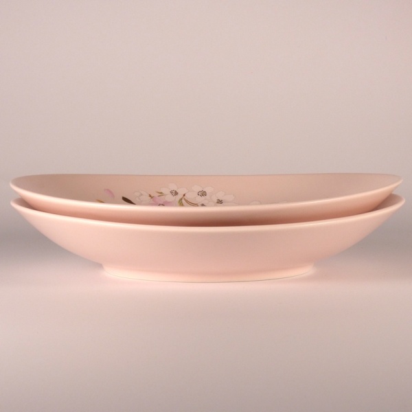 Two stacked pink and gold sakura design dishes