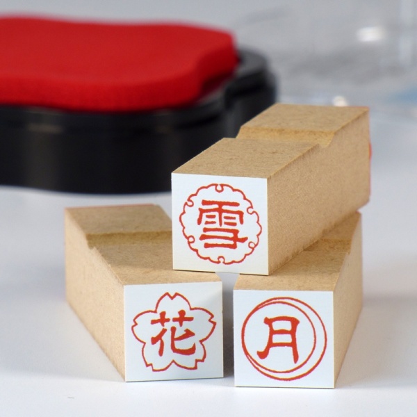 Set of three Japanese craft stamps with stamp pad in the background